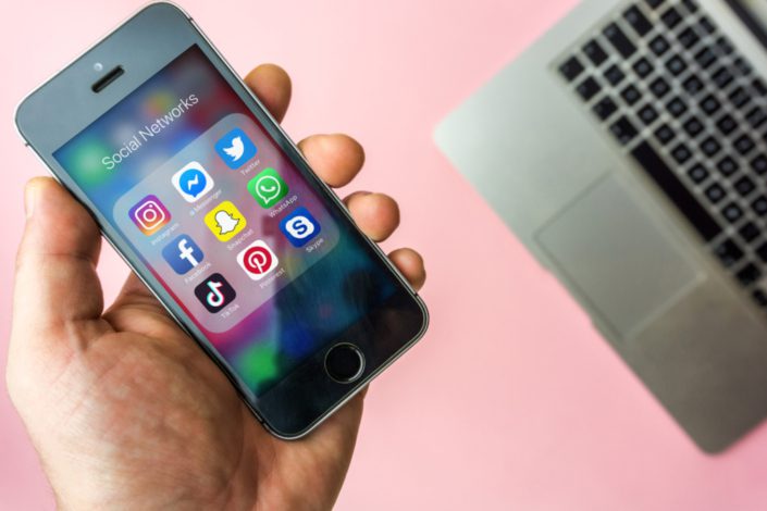 Vienna Austria – March.20 2019, Woman holding Apple SE with icon